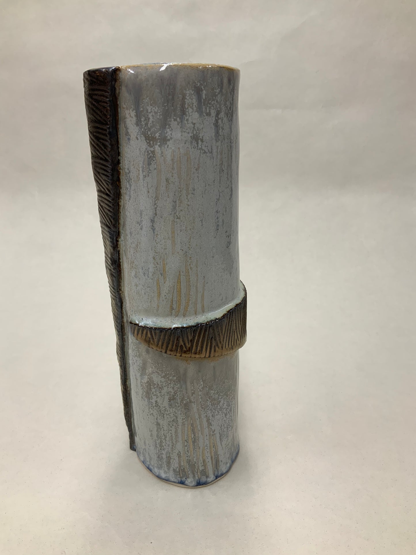 grey cream and gold vessel