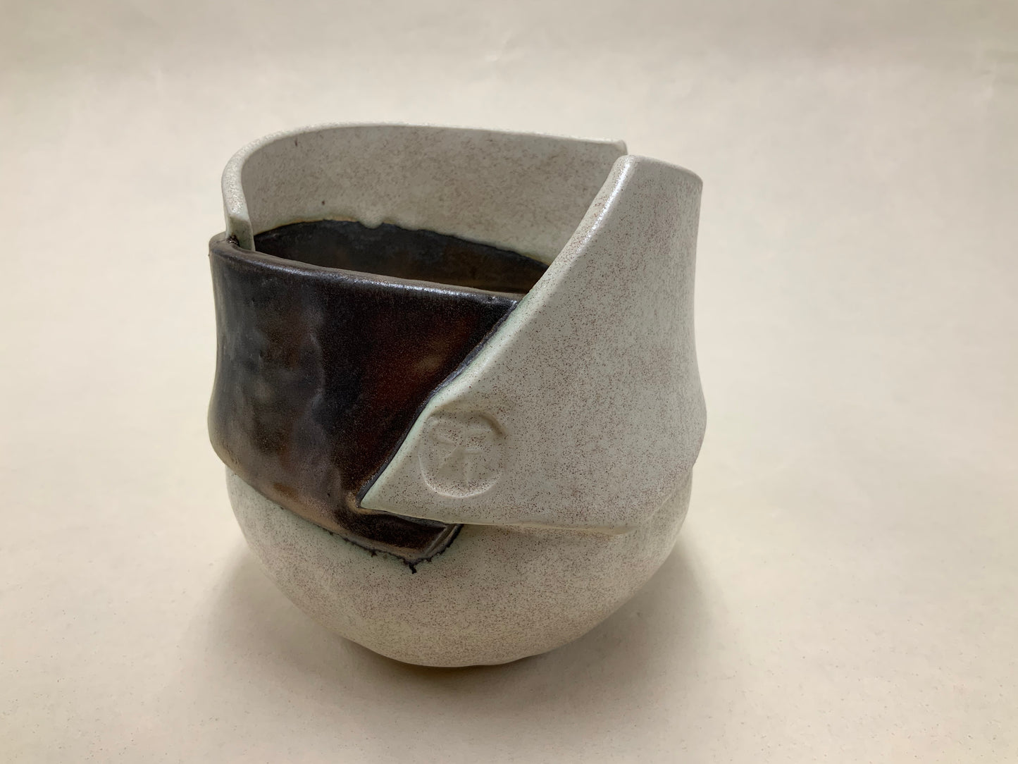 speckled cream and gold banded vessel