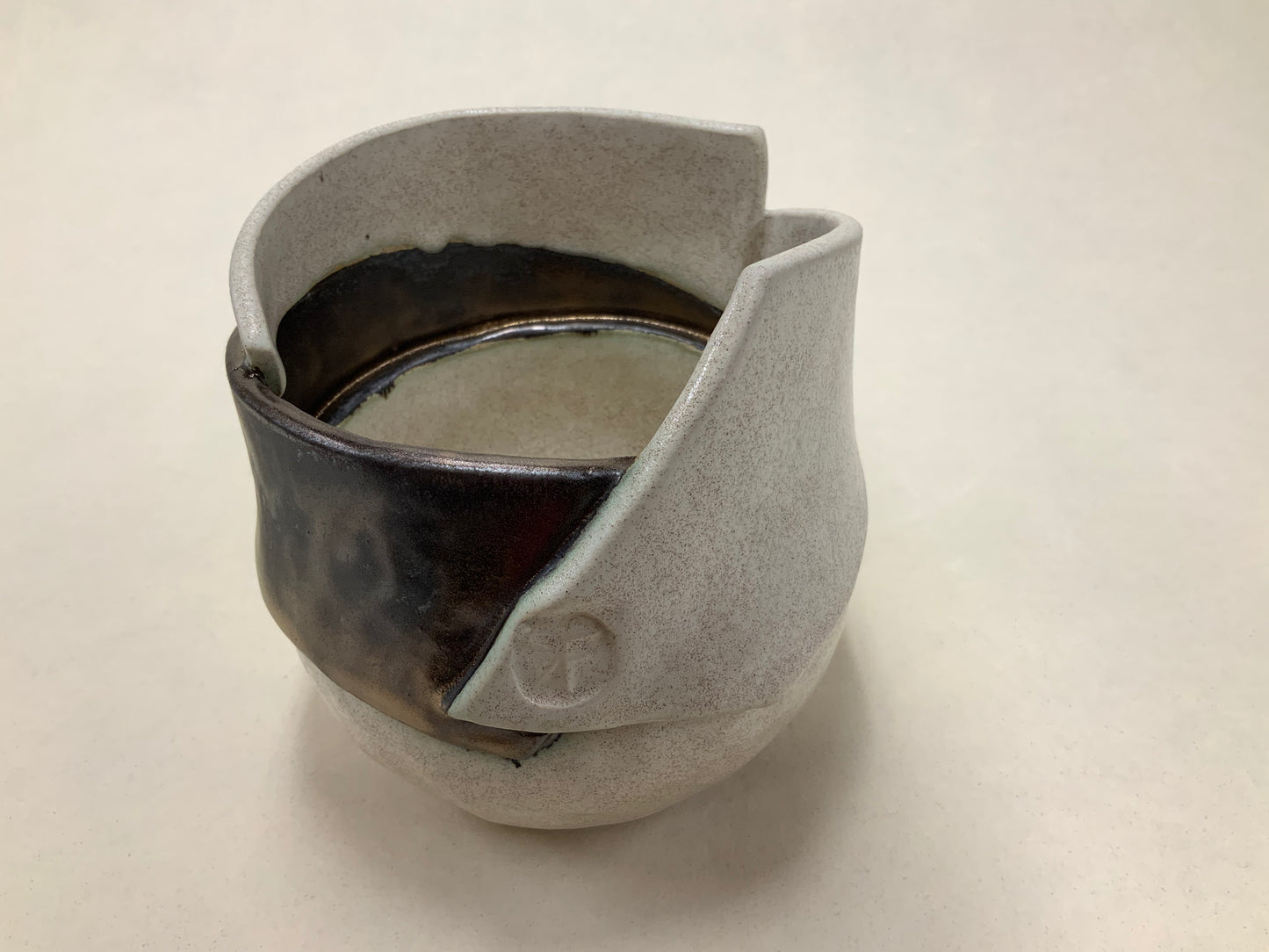 speckled cream and gold banded vessel