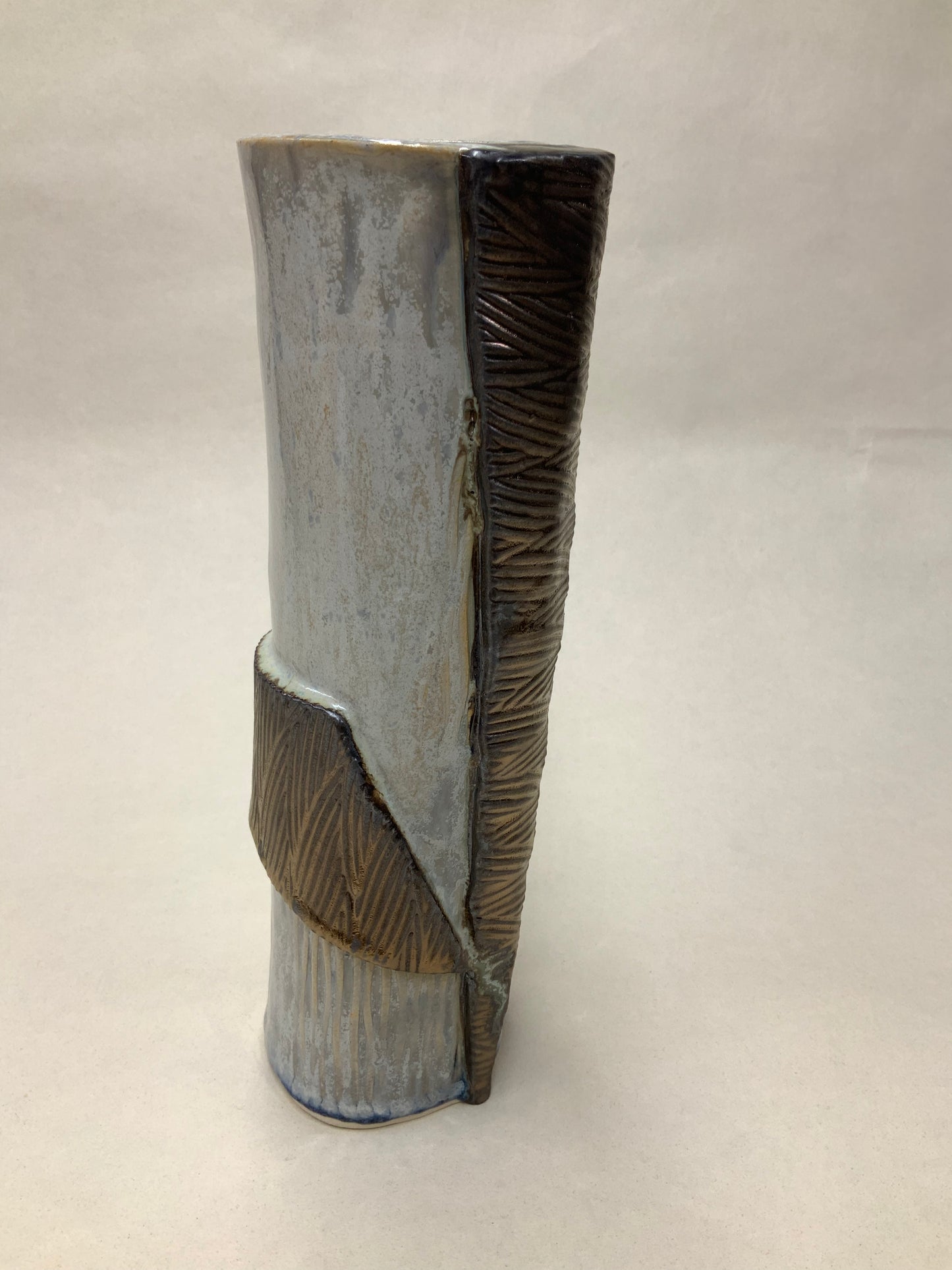 grey cream and gold vessel