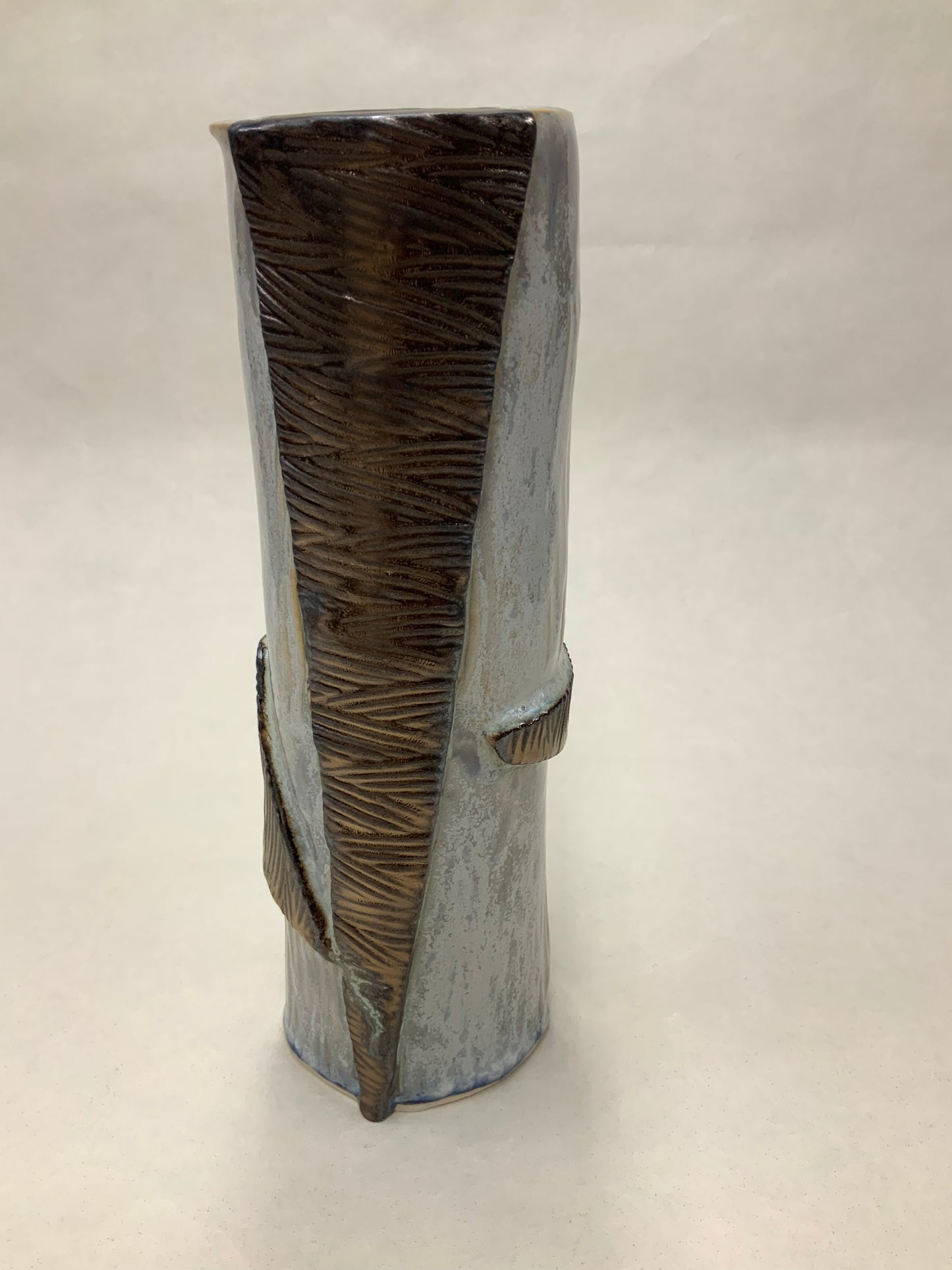 grey cream and gold vessel