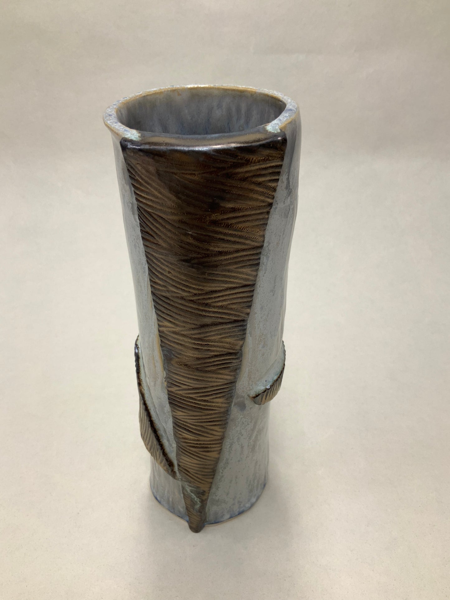 grey cream and gold vessel