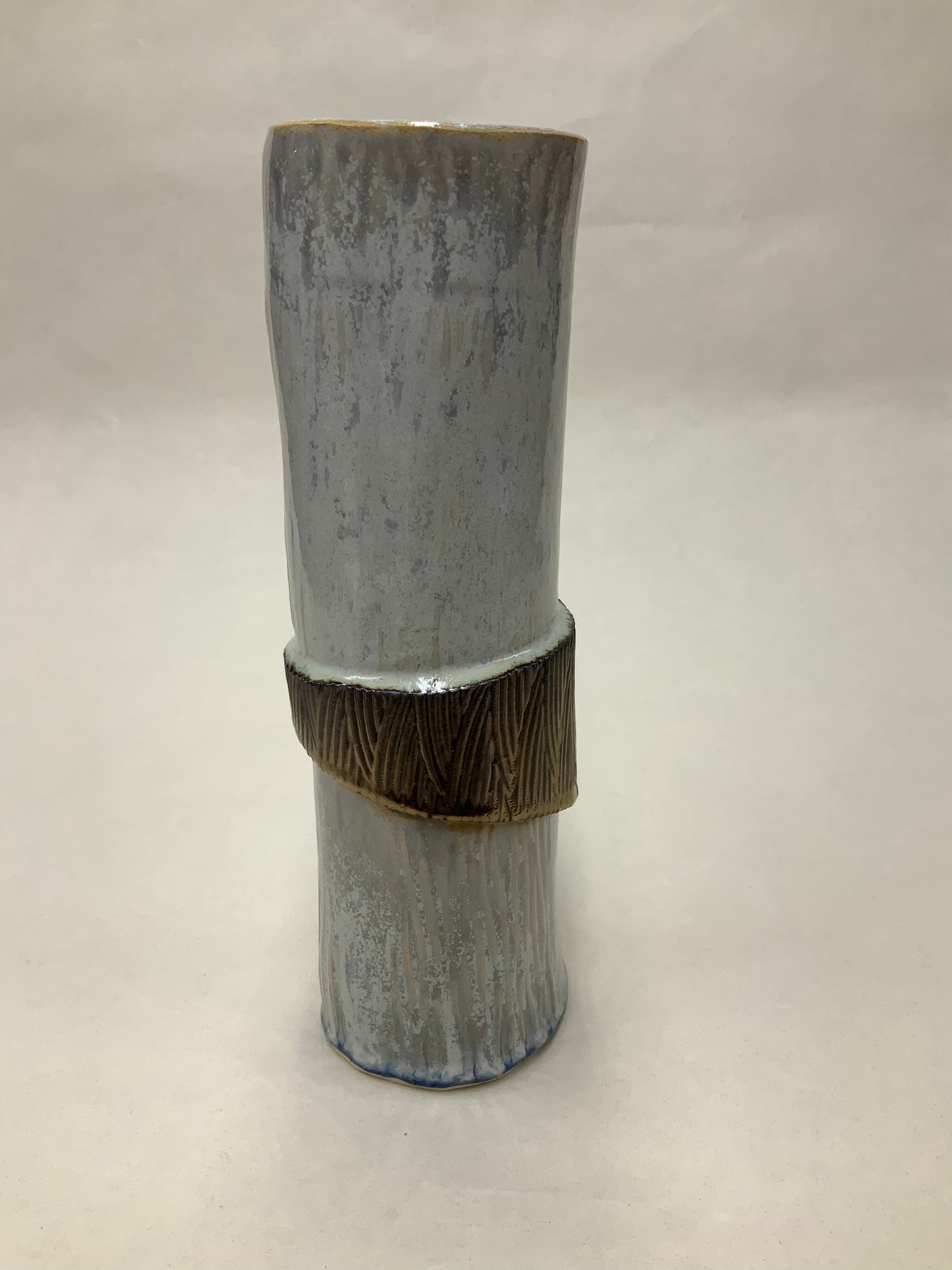 grey cream and gold vessel