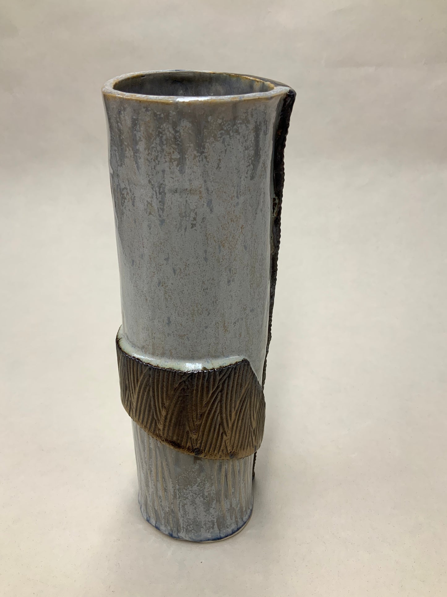 grey cream and gold vessel