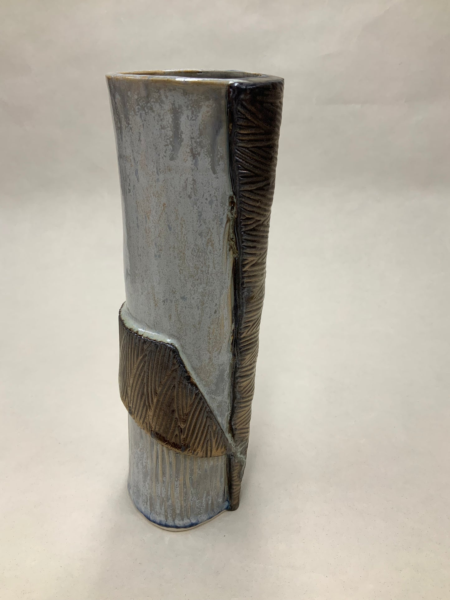 grey cream and gold vessel