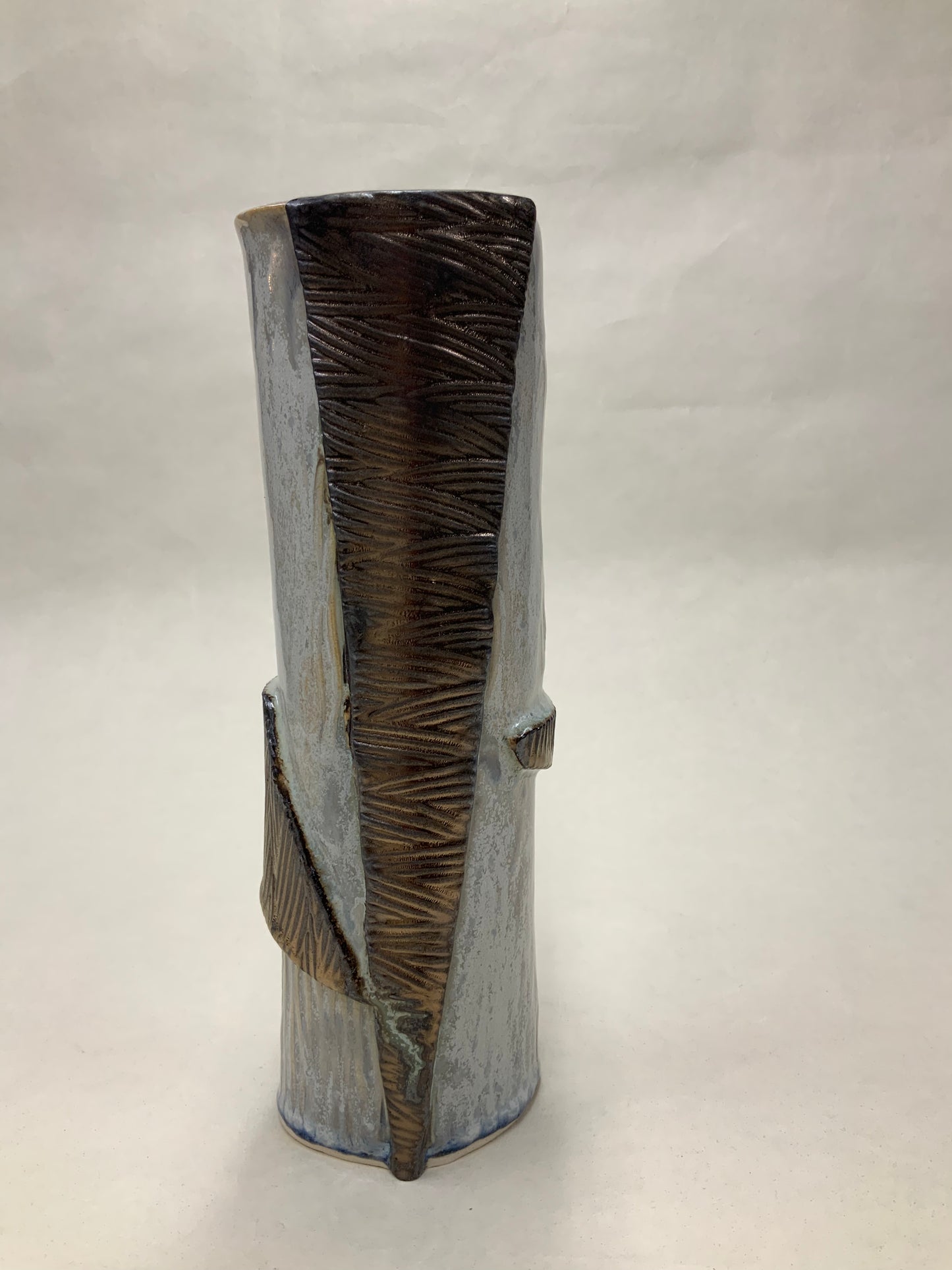 grey cream and gold vessel